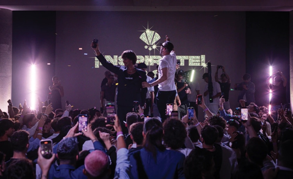 Celebration on the Inspirar stage: the packed room filming on their phones